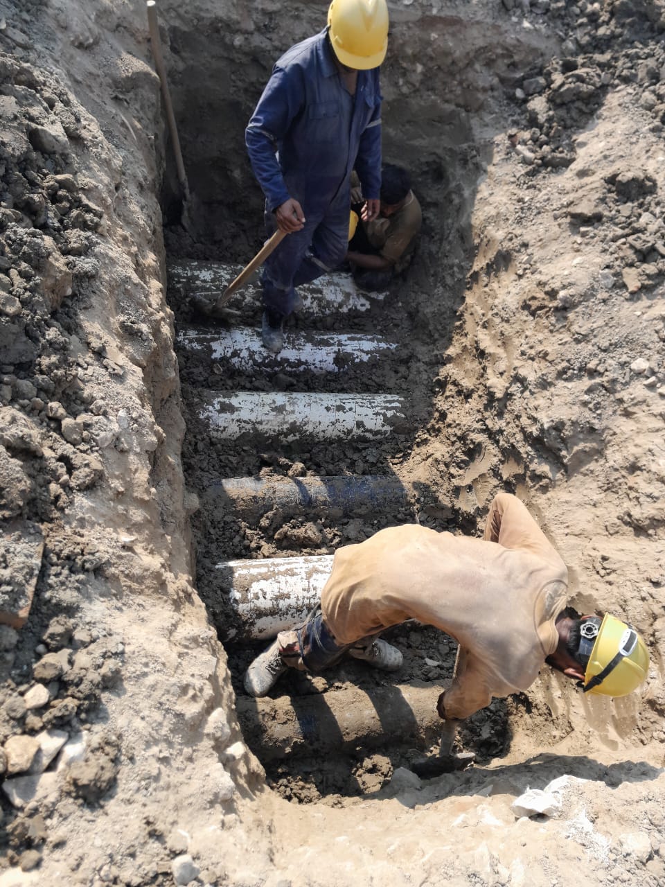 Underground pipeline trench excavation and pipe laying