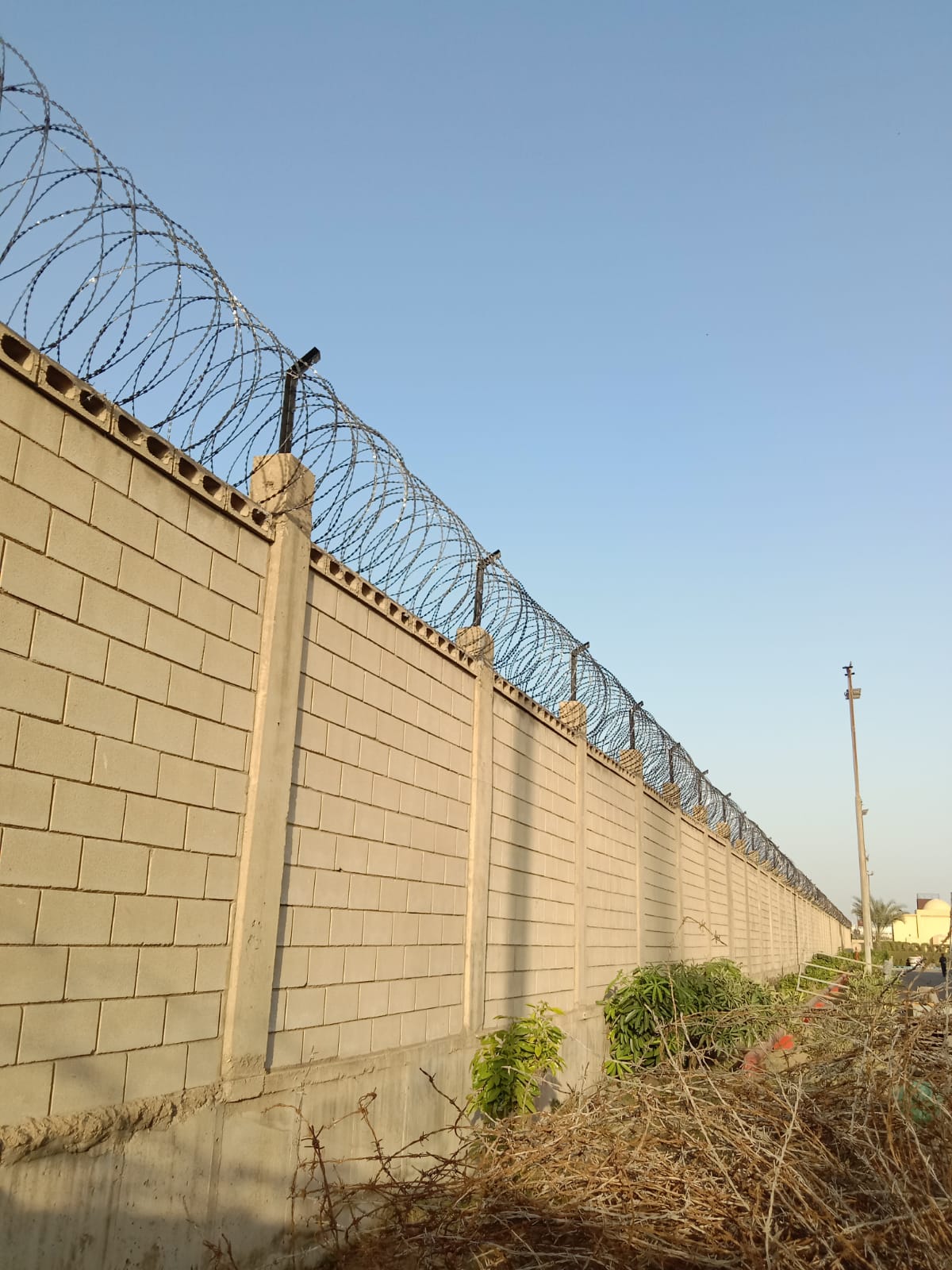 Boundary wall with concertina razor wire installed